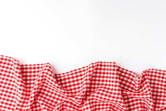 Gingham cloth on white background with copyspace. Top view