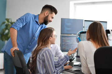 Team of programmers working in office