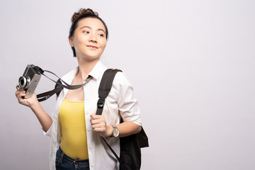 Happy woman holding camera over background