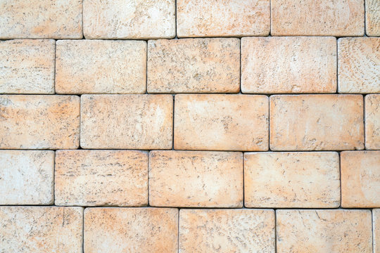 Texture of yellow brick made of sandstone and limestone. The wall of the house.