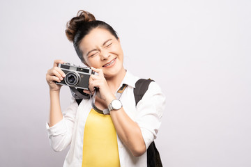 Happy woman holding camera and feel surprise over background