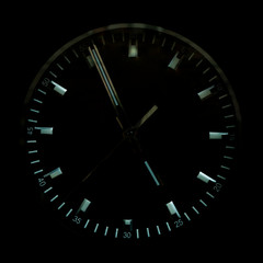 The watch dial is black. Shiny clock hands.