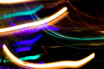 Multicolored lights. Illumination at night in motion. Blurred focus.