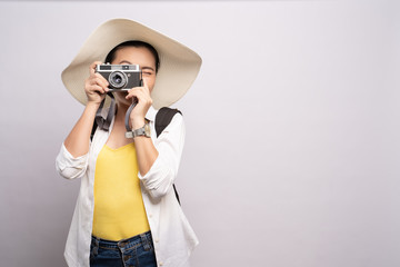 Happy woman take a photo by camera isolated over background