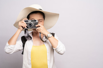 Happy woman take a photo by camera isolated over background