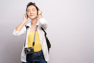 Tourist woman listening music isolated over white background