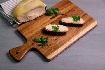 Arzua Ulloa cheese on a wood table with parsley