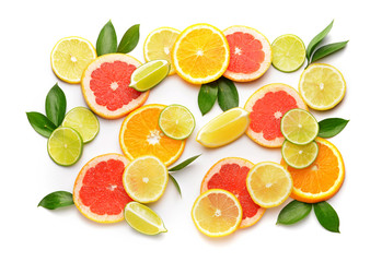 Different sliced citrus fruits on white background