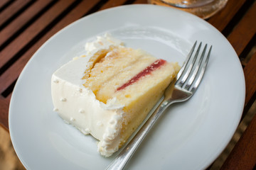 The wedding cake is cut into pieces.