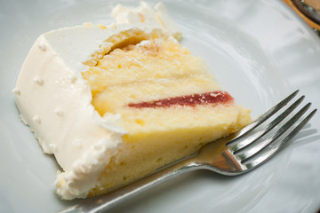 The wedding cake is cut into pieces.