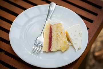 The wedding cake is cut into pieces.