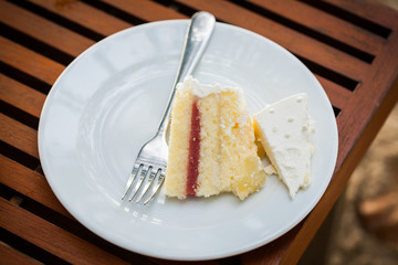 The wedding cake is cut into pieces.