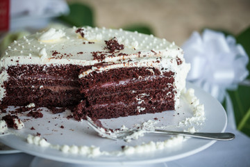 The wedding cake is cut into pieces.