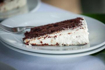 The wedding cake is cut into pieces.