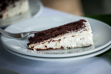 The wedding cake is cut into pieces.