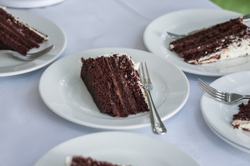 The wedding cake is cut into pieces.