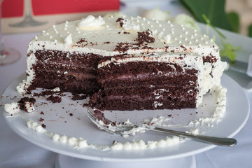 The wedding cake is cut into pieces.