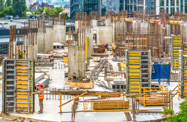 New building under construction and construction site of a residential building. Concrete work is being performed at the site.