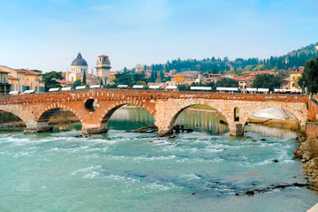 Roman arch bridge over Adige River in Verona. Historical center of European city. Romantic sightseeng trip to Italy