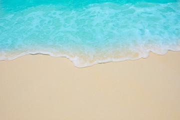 Soft waves of blue sea on the Maldives beach for the background.