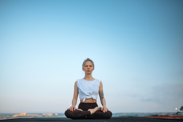 Girl practice yoga early morning on pier