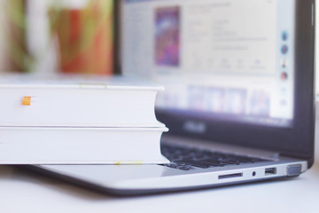 Books and Laptop. Different Concepts for Information - Social Network or Traditional Literature. Data Sources - Electronic Screen of Computer or Paper Pages of Books, Internet or Papers