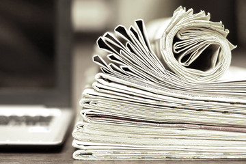 Newspapers and Laptop. Different Concepts for News - Social Network or Traditional Tabloid Journals. Data Sources - Electronic Screen of Computer or Paper Pages of Magazines, Internet or Papers