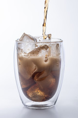 glass of cola with ice isolated on white background
