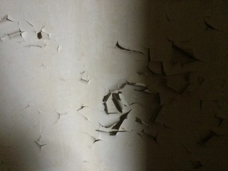 Old wall with peeling paint in an abandoned building