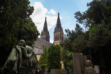 Tombstones and statues at the Vysehrad cemetery and Basilica of Saints Peter and Paul on the grounds of Vysehrad Castle in Prague, Czech Republic.