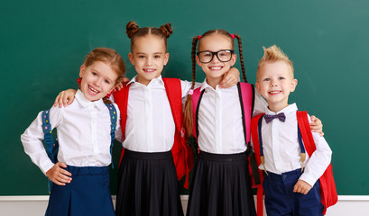 funny group children   schoolboy  and schoolgirl, student boy  and girl about school blackboard.