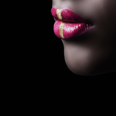 closeup of black woman lips with red and golden colors