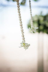Floral arrangement at a wedding ceremony on beach.