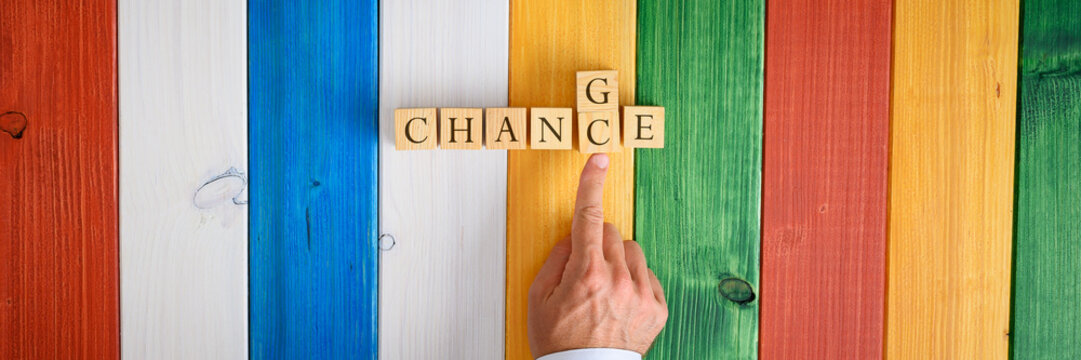 Male finger replacing letters C and G in a word Chance