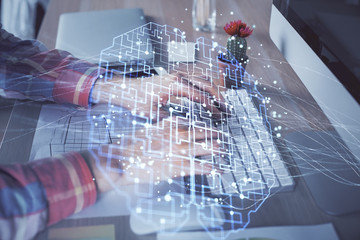 Man typing on keyboard background with brain hologram. Concept of big Data. Double exposure.