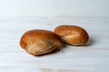 rye mini baguettes on white wooden table