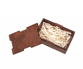 Open wooden box with filling material inside. Empty natural wooden box with decorative straw for happy gifts.
