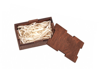Open wooden box with filling material inside. Empty natural wooden box with decorative straw for happy gifts.