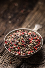 Mixed peppercorns red black and white in bowl - Close-up