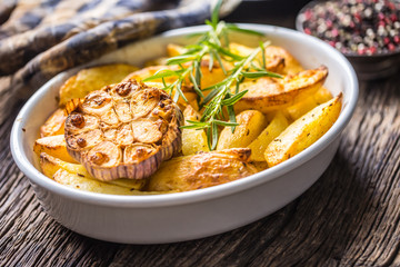 Roasted Garlic together with potatoes rosemary salt and spices