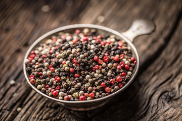 Mixed peppercorns red black and white in bowl - Close-up