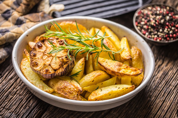 Roasted Garlic together with potatoes rosemary salt and spices