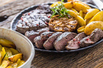 Grilled beef Rib Eye steak with garlic american potatoes rosemary salt and spices