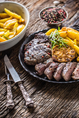 Grilled beef Rib Eye steak with garlic american potatoes rosemary salt and spices