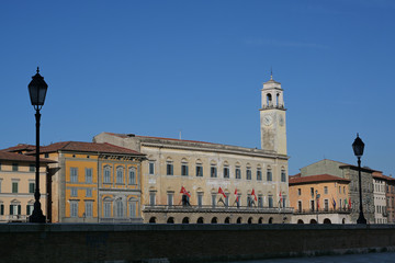 Palazzo Pretorio in Pisa, the seat of the municipal library on the Lungarno Galilei, near the bridge Ponte di Mezzo on the river Arno, Italy