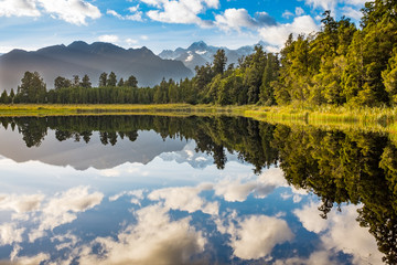 The incredibly beautiful Lake Matheson, New Zealand with the reflection of the stunning Southern Alps and the majestic Mt Cook in the still waters