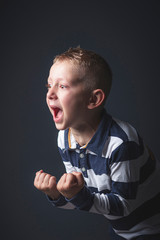 6 year old kid caucasian boy screaming in despair.