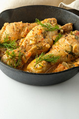 Spicy chicken in a sauce in a frying pan. top view from above