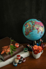 School supplies on blackboard background ready for your design