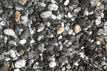 orange shining sea boulders wet by wave texture - nice abstract photo background